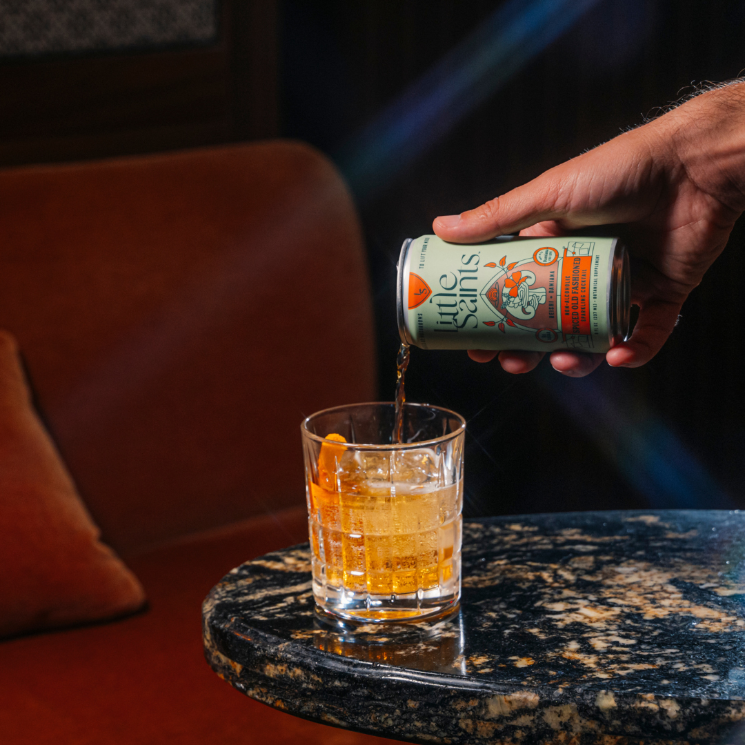 Spiced Old Fashioned cocktail with cloves and orange peel garnish in a glass
